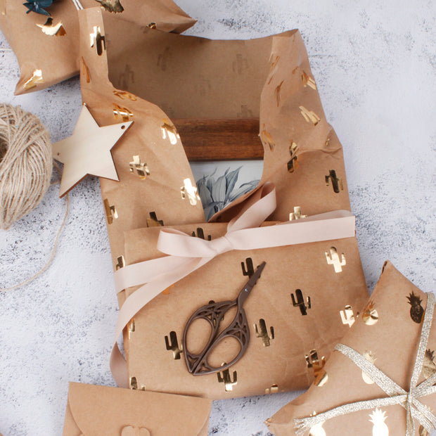Brown kraft wrapping paper gift with a beige gift bow