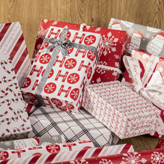 Festive Christmas gift wrapping paper & ribbons with snowflakes, Santa, candy canes—wrapped boxes ideal for holiday gifting, from LaRibbons and Crafts.