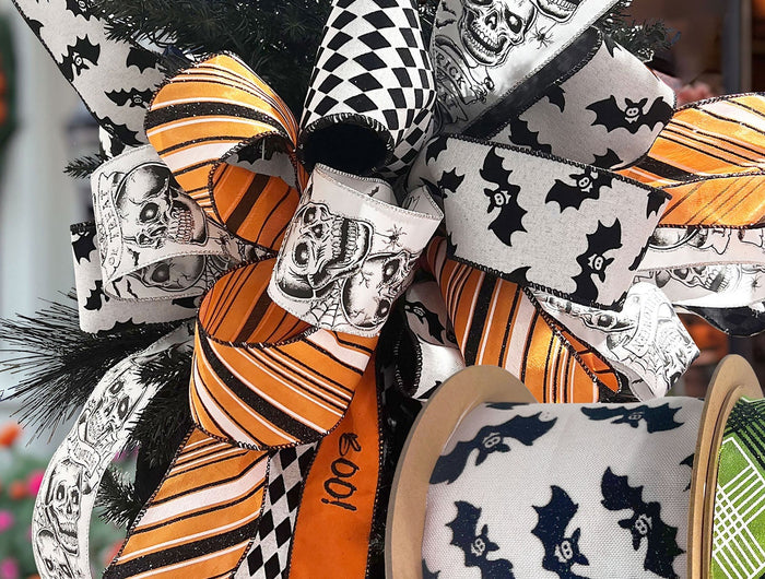 Halloween wired ribbons with skulls, bats, and festive patterns, arranged as bows. Perfect for Halloween decor & crafts at LaRibbons and Crafts.