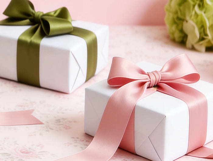 Pink single face satin ribbon (on white gift boxes) — smooth, ideal for gift wrapping & celebrations.