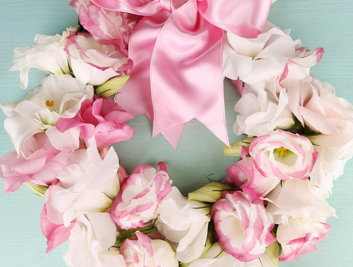 A large emerald green Double Face Satin Ribbon bow adorns Christmas gift boxes. The ribbon’s glossy double-sided satin adds elegance, perfect for gift wrapping, crafts, and festive décor.
