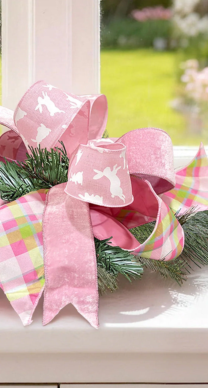 Two spools of holiday wired ribbon—plaid (red/green/gold) and red velvet—with pine cones, evergreens. Ideal for Christmas wrapping, wreaths at LaRibbons and Crafts.