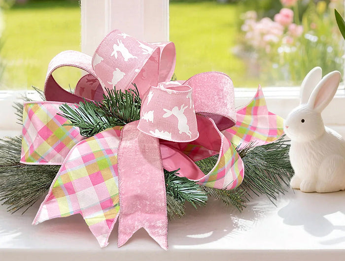 Two spools of holiday wired ribbon—plaid (red/green/gold) and red velvet—with pine cones, evergreens. Ideal for Christmas wrapping, wreaths at LaRibbons and Crafts.