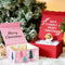 Several beautifully designed Christmas gift boxes with various patterns, placed around a Christmas tree, creating a warm and festive holiday atmosphere.