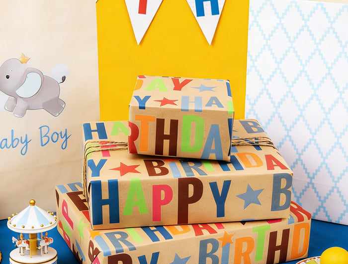 Kraft wrapping paper (colorful "Happy Birthday"+stars) — sturdy, perfect for birthday gift wrapping.