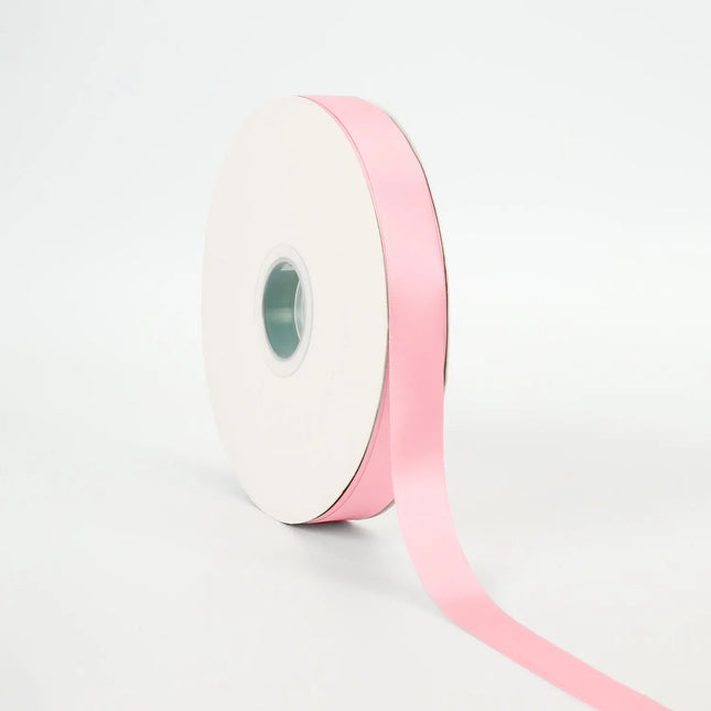 Spool of pink single-face satin ribbon, smooth sheen for gift wrapping & crafts.