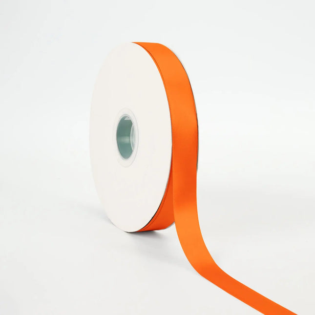 Spool of Torrid Orange single-face satin ribbon, smooth sheen for gift wrapping & crafts.