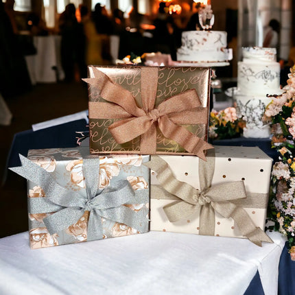 Rose gold "love" script wrapping paper + satin bow; romantic event gift wrapping.