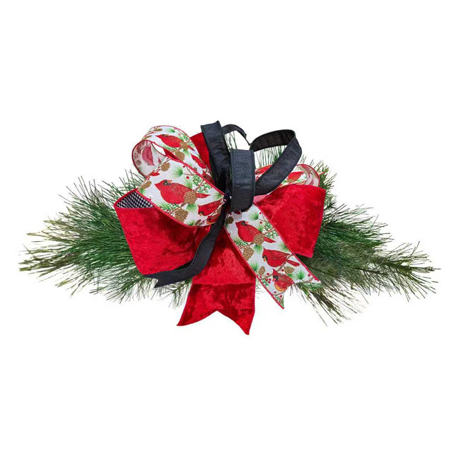 Christmas bow crafted from cardinal-printed, black sheer, red velvet ribbons with green pine branches.