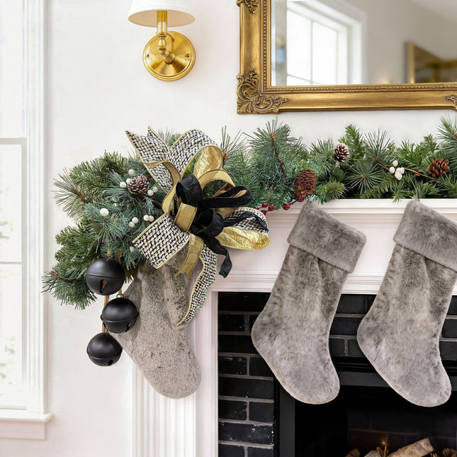 Christmas fireplace garland: houndstooth bow, gold/black ribbons, pine, bells & fuzzy stockings.