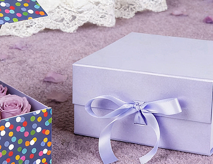 Assorted gift boxes: open navy polka-dot (lavender roses), stacked lavender/white ribbon boxes. Smooth, ideal for romantic gifting.