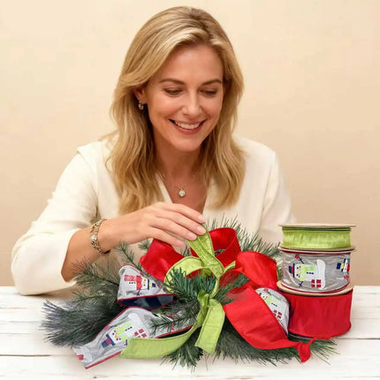 Showcases festive ribbons: red ribbon, green ribbon, and gray with snowman embroidery, used in a pine-branch Christmas decoration.