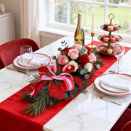 Pink striped & red satin ribbon bow (pine) on dining table; holiday celebration decor.