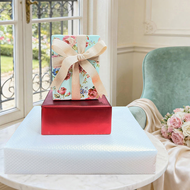 Wrapping paper trio: white quilted, blue floral, matte red; gift wrapping.