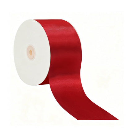 Spool of red double face satin ribbon, ideal for luxury gift wrapping, wedding decor, and crafting with its smooth, glossy finish on both sides.