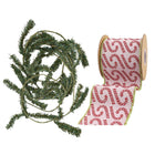 A coil of green artificial pine garland and a spool of pink ribbon with red candy cane patterns, ideal for Christmas decorating.