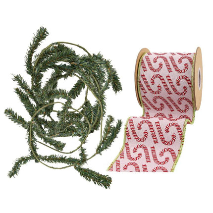 A coil of green artificial pine garland and a spool of pink ribbon with red candy cane patterns, ideal for Christmas decorating.