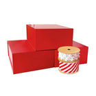 Three red gift boxes with festive red-white striped and pom-pom ribbons, perfect for Christmas gifting and packaging.