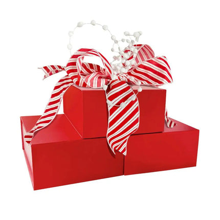 Red gift boxes adorned with a large red-and-white striped ribbon bow and white pom-pom decor.