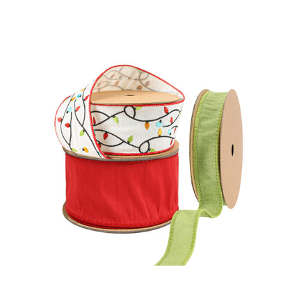Three spools of Christmas ribbons: a white ribbon with colorful Christmas light patterns, a red ribbon, and a light green ribbon.