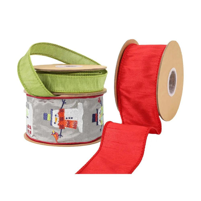 Three spools of ribbon are shown: a green textured ribbon, a gray ribbon with embroidered snowmen, and a red textured ribbon.