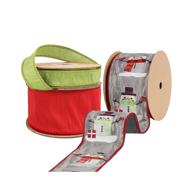Three spools of ribbon are shown: a green textured ribbon, a gray ribbon with embroidered snowmen, and a red textured ribbon.