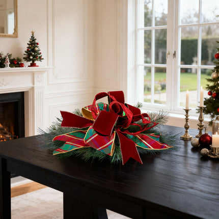 Festive table: red velvet & plaid ribbon bow, warm holiday atmosphere in chic living room.
