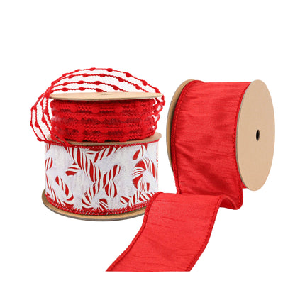 Festive ribbons: red pom-pom trim, a candy cane-patterned spool, and a solid red ribbon, perfect for holiday decor.