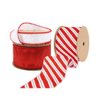 Three spools of ribbons: a white ribbon with red pom-pom trim, a solid red ribbon, and a red-and-white striped ribbon with a glittery finish.