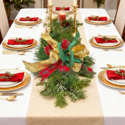 A Christmas table has a pine centerpiece with gold, red (glitter pine), and green ribbons.