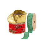 Three spools of Christmas ribbons: a metallic gold ribbon, a red ribbon with glittery pine tree patterns, and a green ribbon.