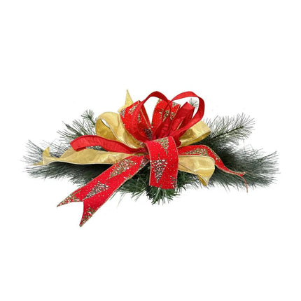A Christmas pine decor adorned with ribbons—metallic gold, red with glitter pine patterns, and red—creating a holiday decorative effect.