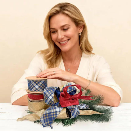 Festive ribbons—blue plaid, red, gold metallic—craft a Christmas decor piece with pine branches, plus spools of these ribbons.