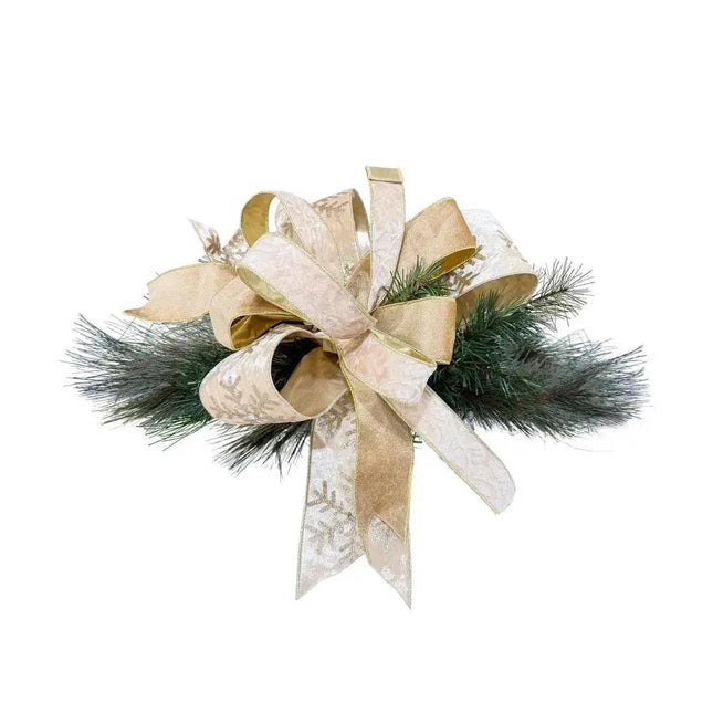 Luxurious Christmas bow made of golden snowflake and lace-patterned ribbons, paired with green pine branches, perfect for festive decoration.