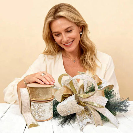 Elegant woman showcases Christmas ribbon set: golden velvet, lace with gold edge, snowflake-embossed with rhinestones, plus a gorgeous bow decor.