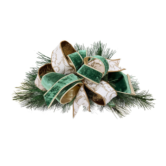 Christmas bow: dark green velvet & white-gold scroll ribbons on pine. Luxe festive textures.