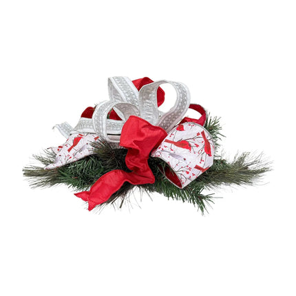 Christmas ribbon arrangement – red, cardinal-printed, silver lace ribbons on green pine.