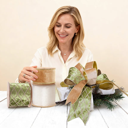 Woman crafting with elegant holiday ribbons (gold velvet, green velvet, ivory velvet) for Christmas decor and gift wrapping, DIY projects.