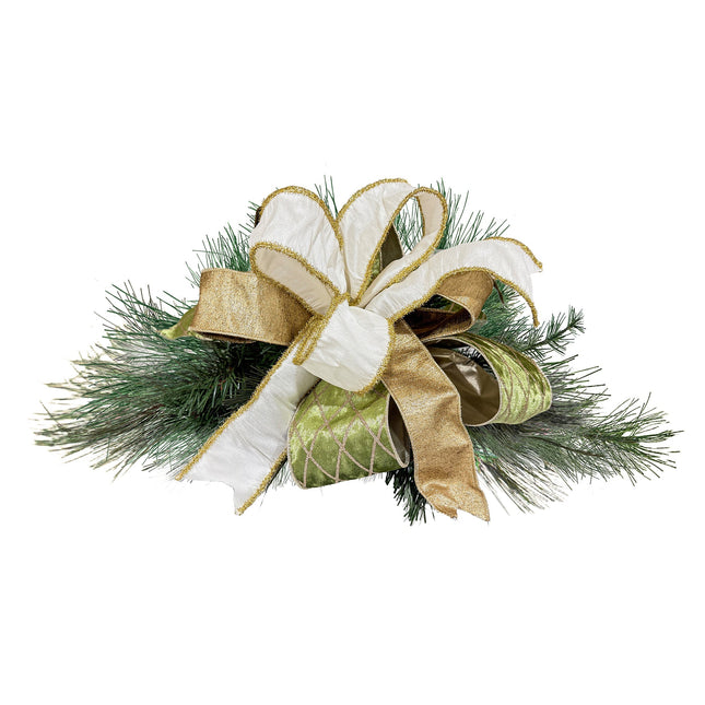 Christmas bow with white, gold, green ribbons, paired with green pine branches, elegant design.