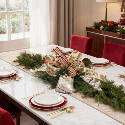 Christmas dining table setup with pine centerpiece, pine cone-print ribbon, gold velvet ribbon, red-gold embroidered ribbon.