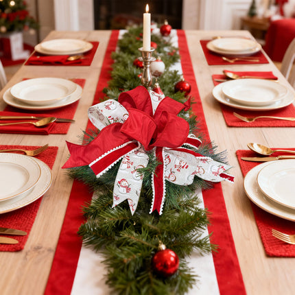 Christmas dining table with floral decor (red & snowman ribbons) on pine runner, warm festive atmosphere.