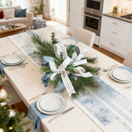 Silver and blue ribbons adorn a festive pine centerpiece on a holiday dining table, perfect for Christmas decor and ribbon craft projects.