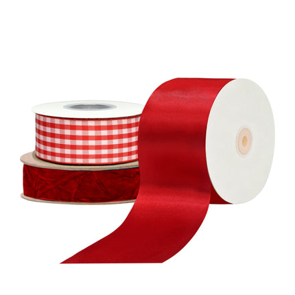 Red ribbon spools: satin, velvet & red-white gingham, glossy/soft textures.