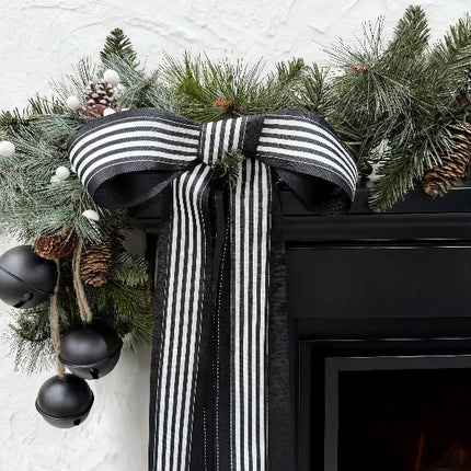 Black-white striped ribbed ribbon bow on Christmas greenery (with pinecones)