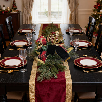 Dark dining table: red plaid/velvet bow + pine – rich holiday decor.
