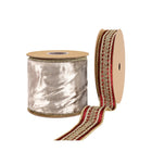 Roll of silver shimmer ribbon with red-gold embroidered intricate scrollwork trim, elegant texture.