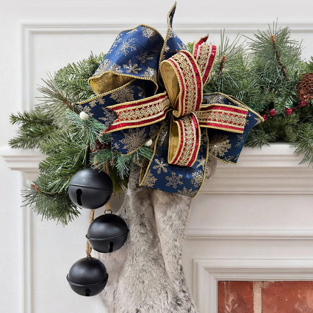 Mantel decor: navy-gold snowflake ribbon bow + burgundy-gold embroidered trim.