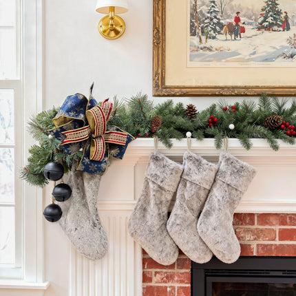 Mantel display: navy-gold snowflake ribbon bow + burgundy-gold trim, plush stockings.