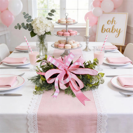 Pink multi-pattern wired ribbon bow as a table centerpiece for baby showers, flowers, and soft pink decor.