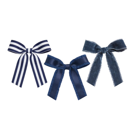 Navy blue ribbon bow collection with three distinct textures: striped grosgrain, ruffle satin, and frayed velvet